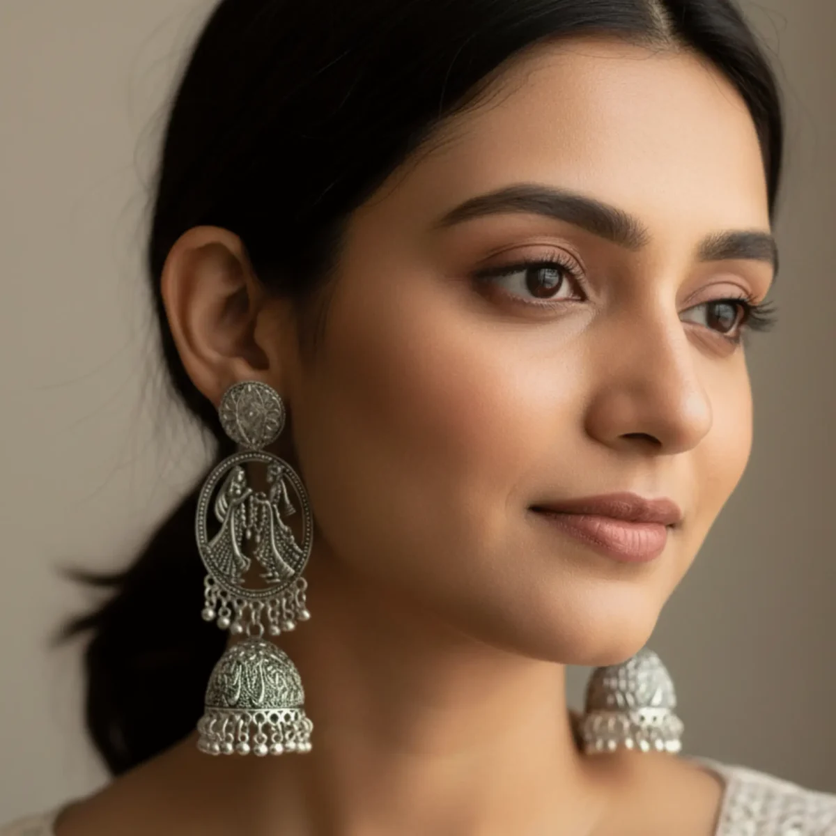 Traditional Silver Jhumka Earrings with Divine Motif